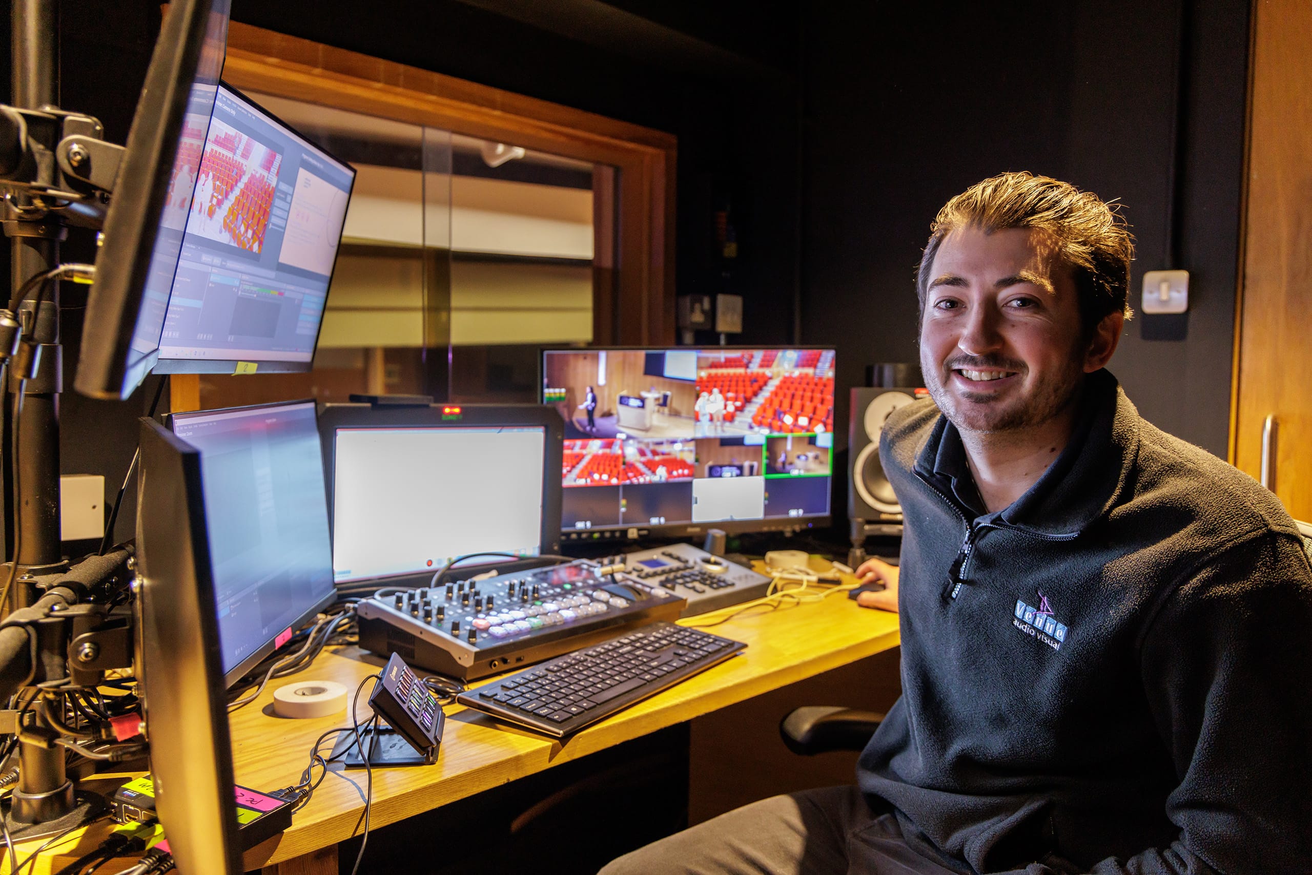 Technician, Luke, in the AV booth. Technician, Luke, in the AV booth.